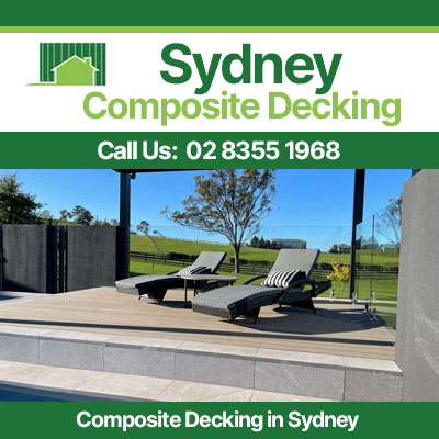Grey composite decking area with lounge chairs overlooking lawn in Sydney